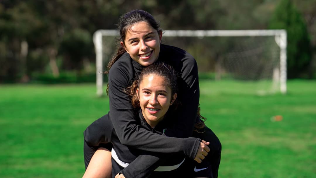 Girls soccer program Adelaide – two players in Mastery Football Academy kit on the pitch