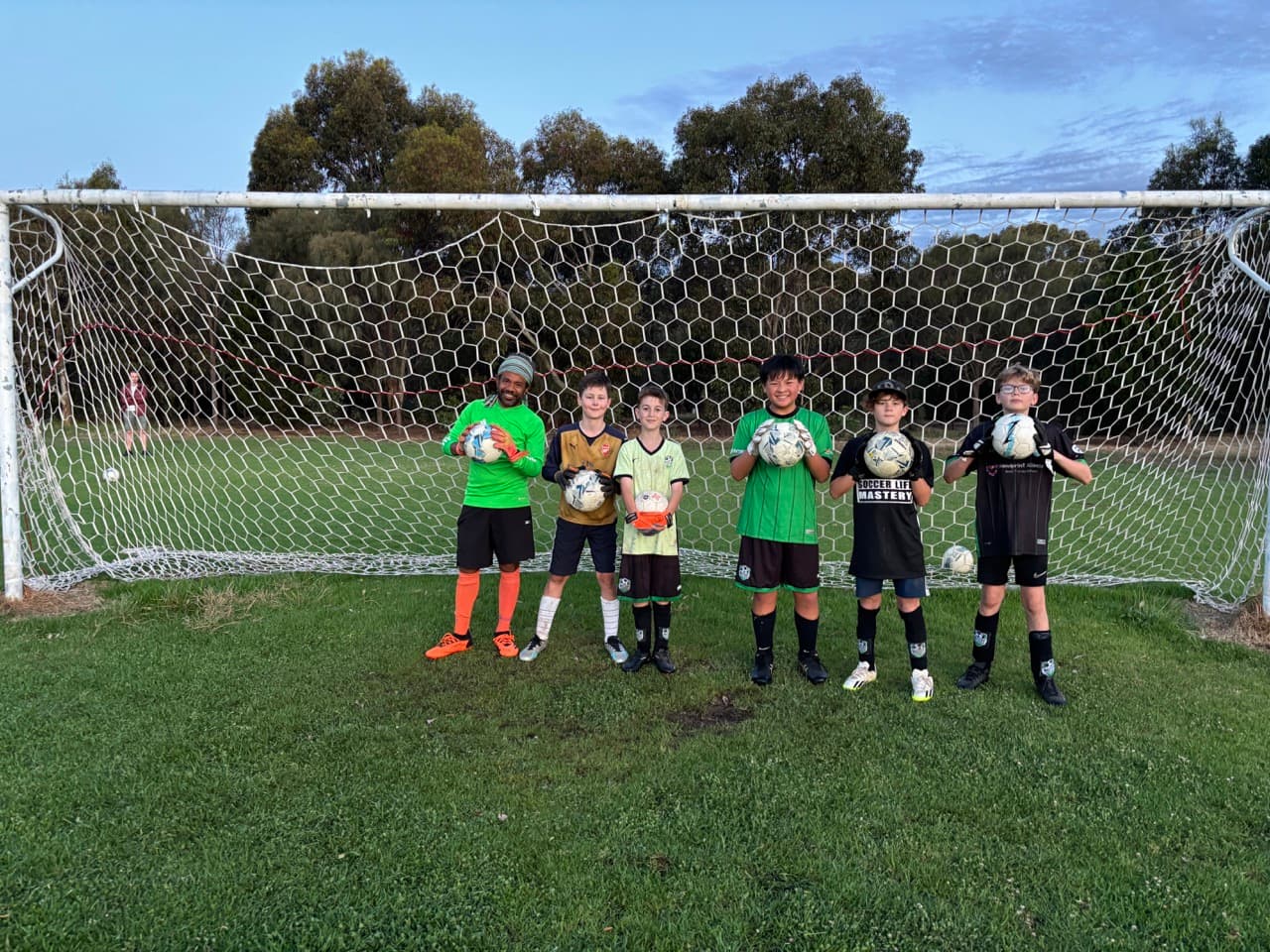 Young goalkeeper being coached during specialist training at Mastery Football Academy Adelaide