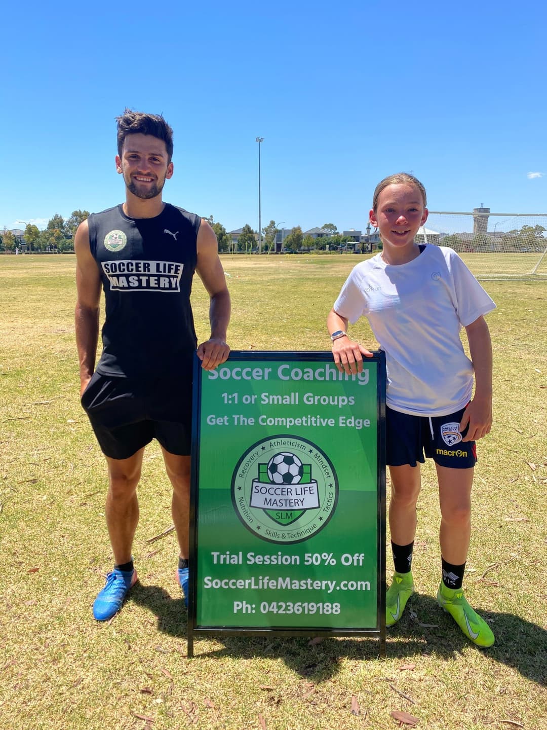 Private soccer coaching Adelaide – Kyle from Mastery Football Academy with a young player on grass pitch, 1-on-1 session